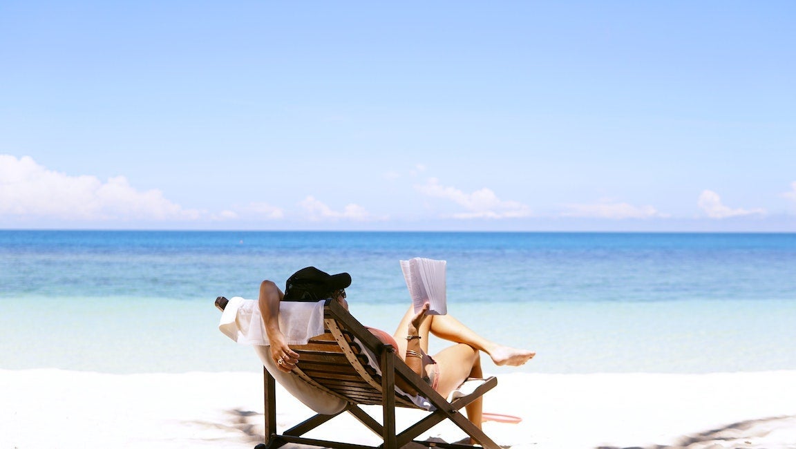 Woman reading on the beach.