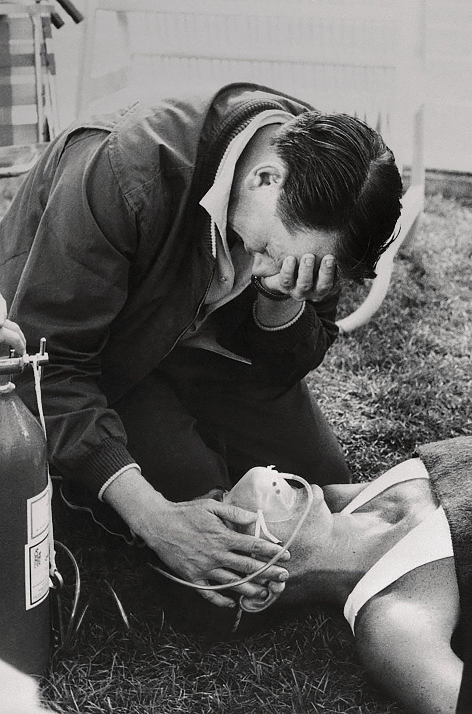 Dr. Brian Corrigan weeps as he administers oxygen to Ron Clarke, Australian, who finished 6th in 10,000-meters in Mexico City on October 13, 1968, then collapsed.