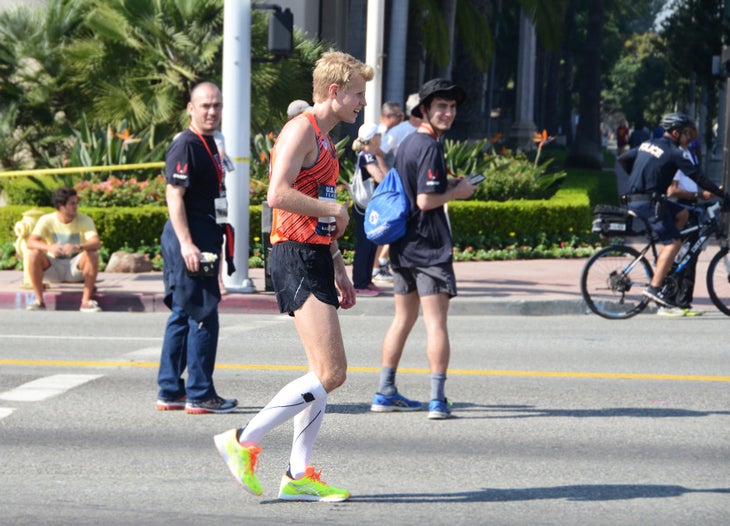 runner walking in marathon after hitting the wall