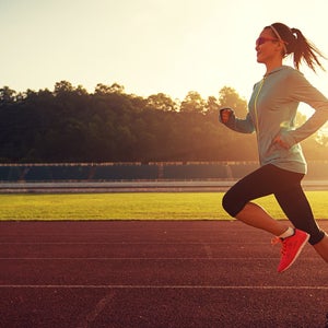 woman runner on track sunrise