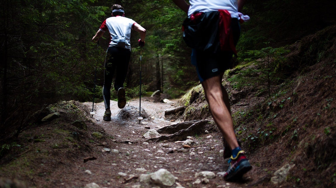 Trail runners running up a hill.