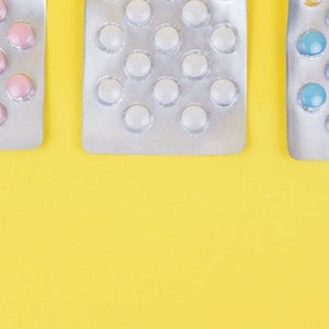Pills against yellow background.