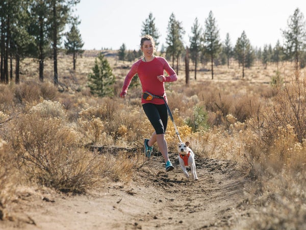 Woman and dog running with dog running gear