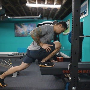 A guy in weight room doing a dorsi flexion exercise to treat an ankle sprain,