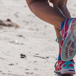 Person running, shows just the calves and feet (ASICs shoes).