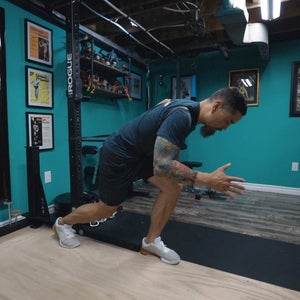 Man in gym doing strength exercises.