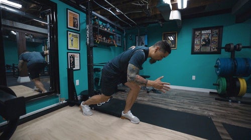 Man in gym doing strength exercises.