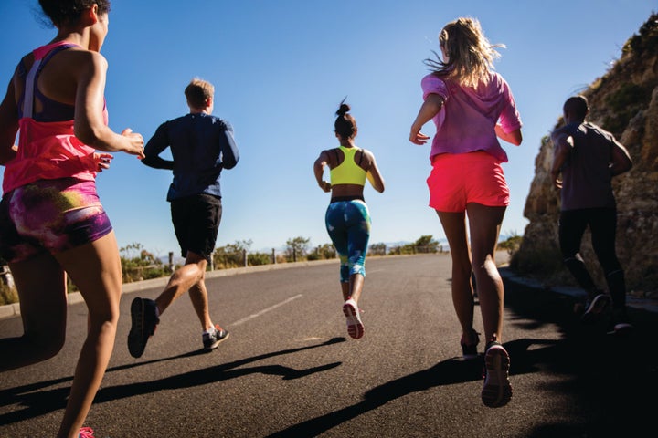 Group of athletes running outdoors in summer