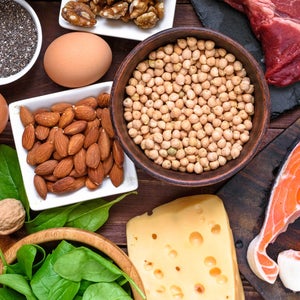 Top view of fish, meat, poultry, nuts, eggs and vegetables on a table
