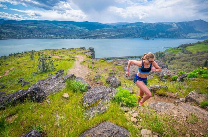 Woman running on a beautiful mountain trail.