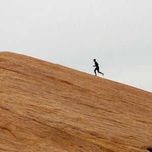 Man running up big hill.