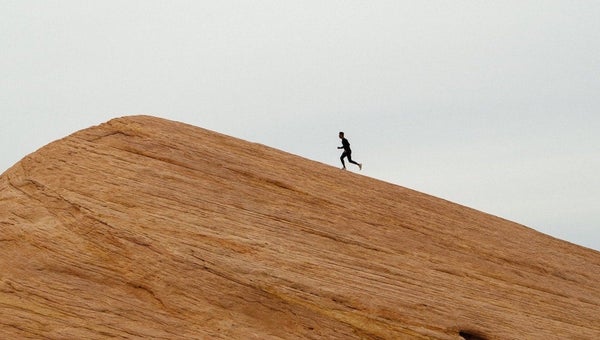 Man running up big hill.