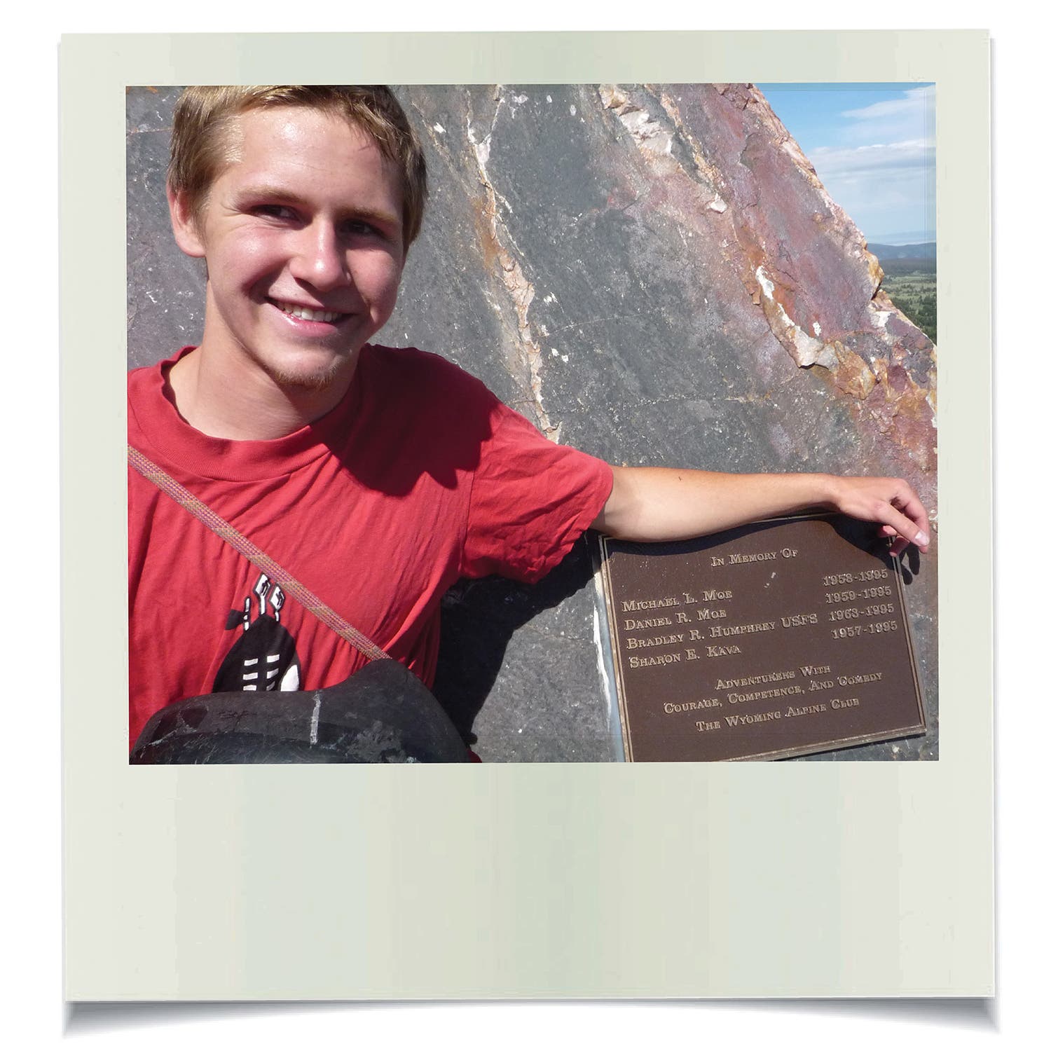 Justin Moe, in 2010, beside a mountaintop plaque honoring members of the WAC