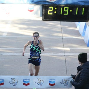 Keira D'Amato reacts to her time as she crosses the line for the Chevron Houston Marathon