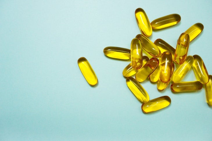 Omega 3 supplements against light blue backdrop.