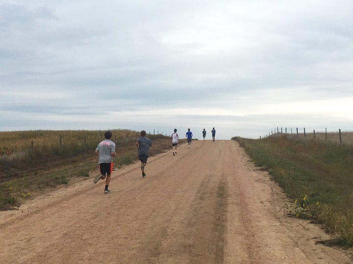 group of runners on long hill