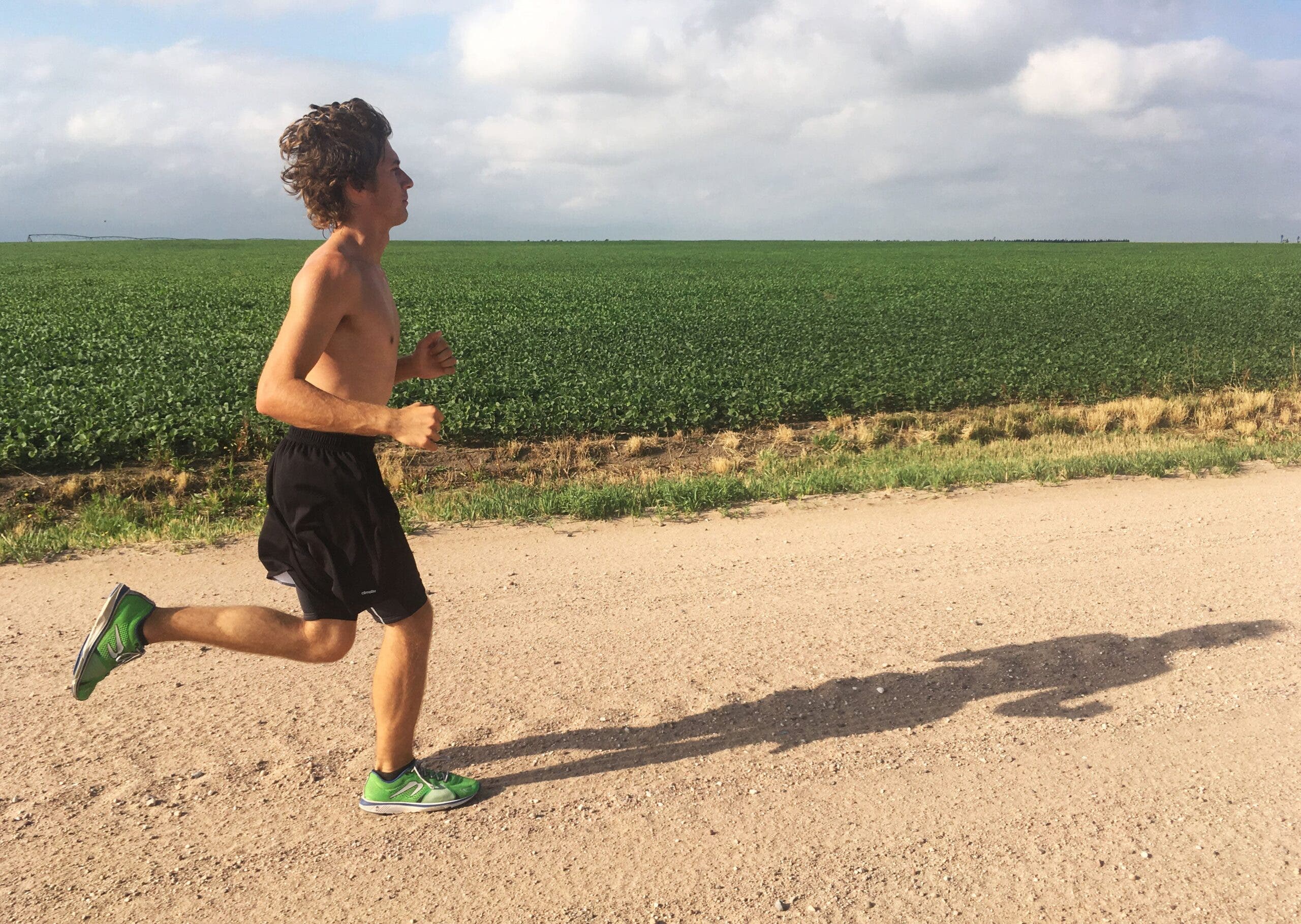 lone male long run corn field dirt road