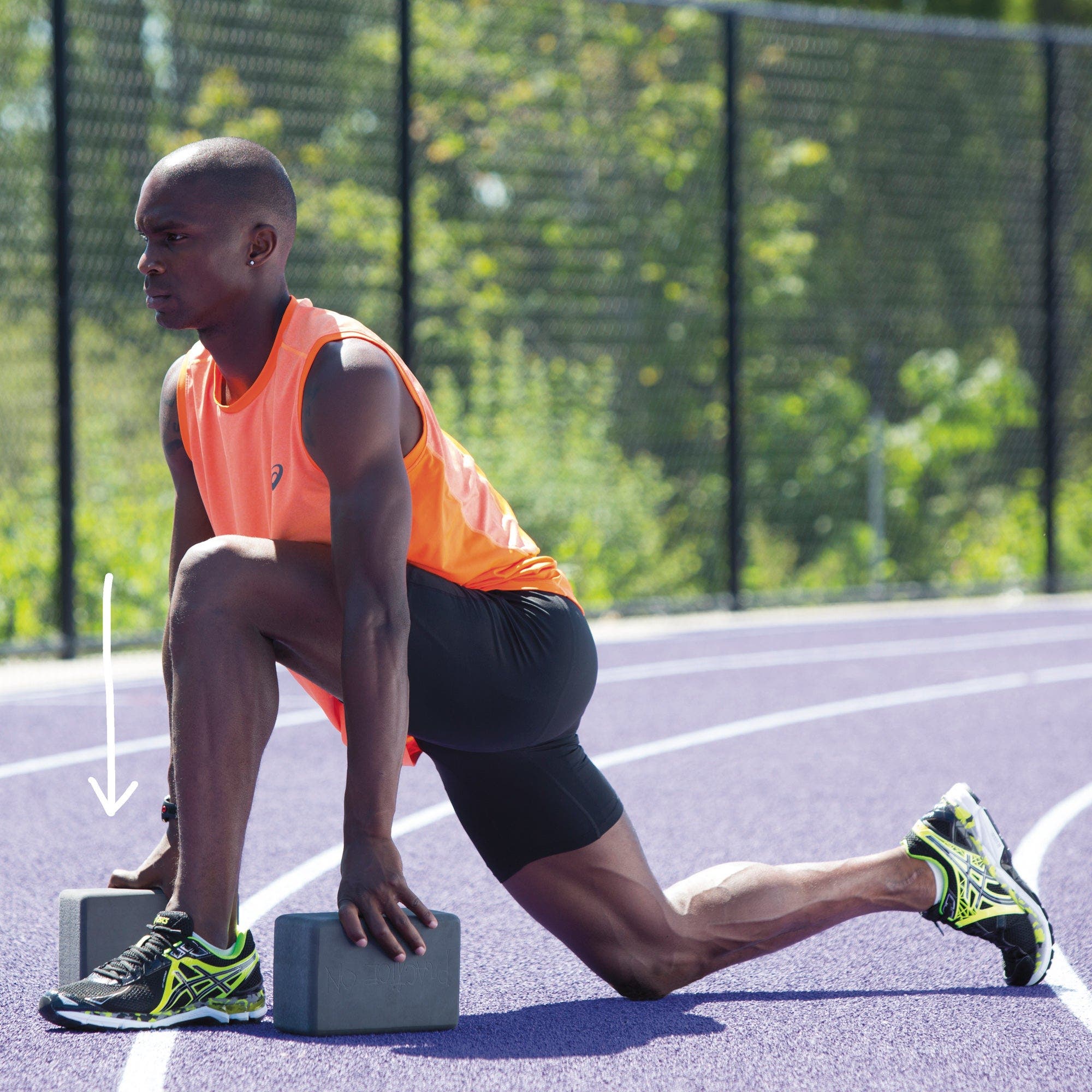 Man in low lunge using yoga blocks for support