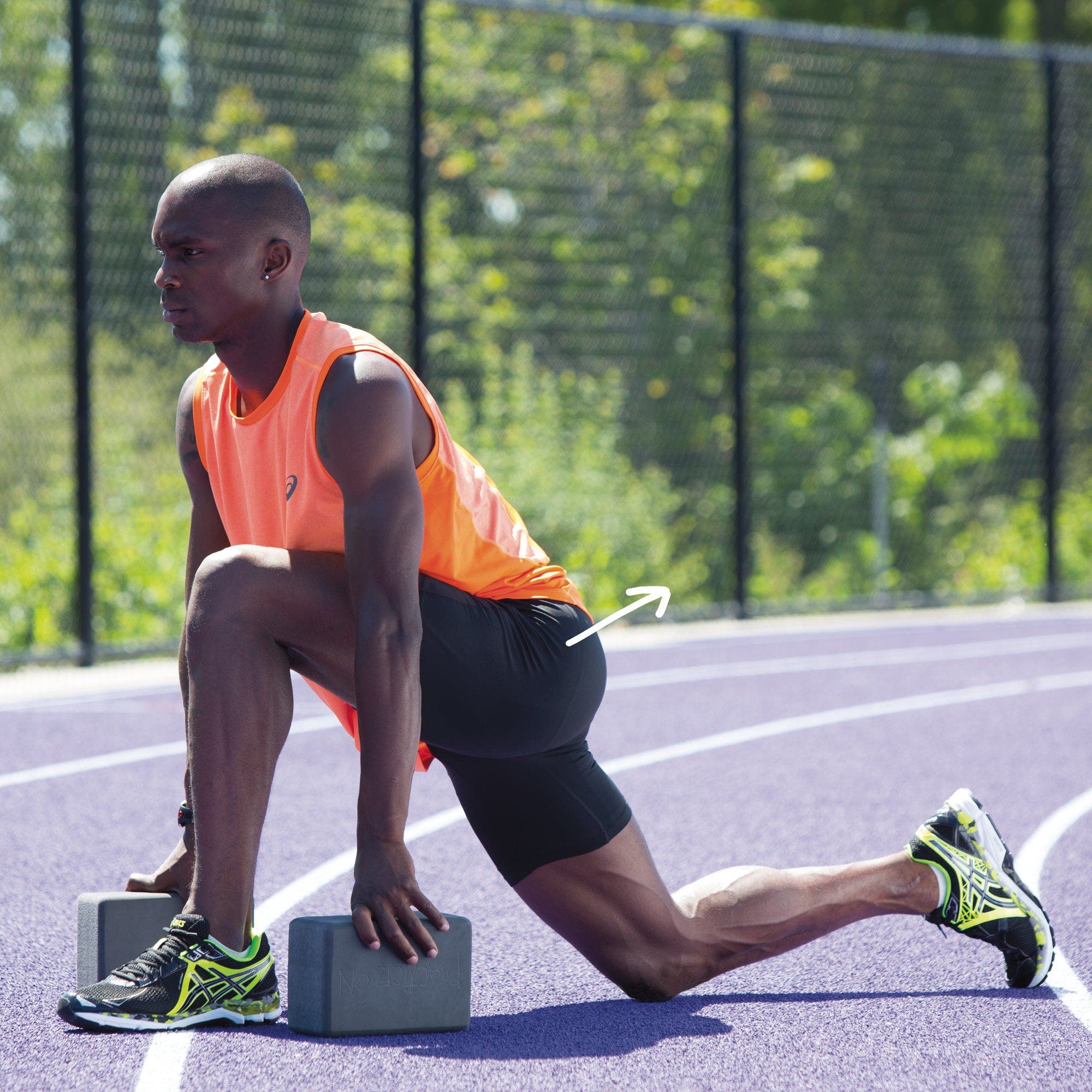 Man in a low lunge supported by yoga blocks