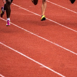 Legs of people racing on a track.