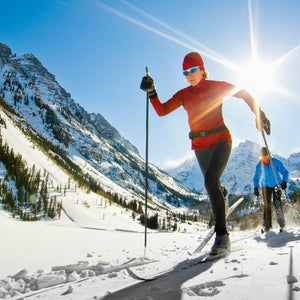Nordic skiers are skiing by Maroon Lake in the Maroon Bells area near Aspen, CO.