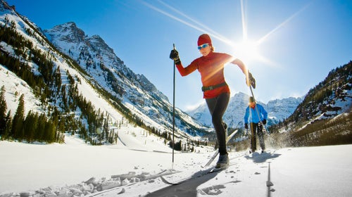 Nordic skiers are skiing by Maroon Lake in the Maroon Bells area near Aspen, CO.