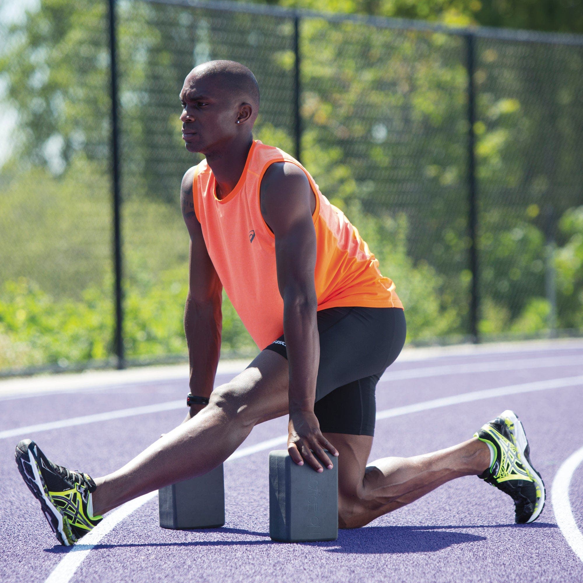Man in a half split with yoga blocks for support
