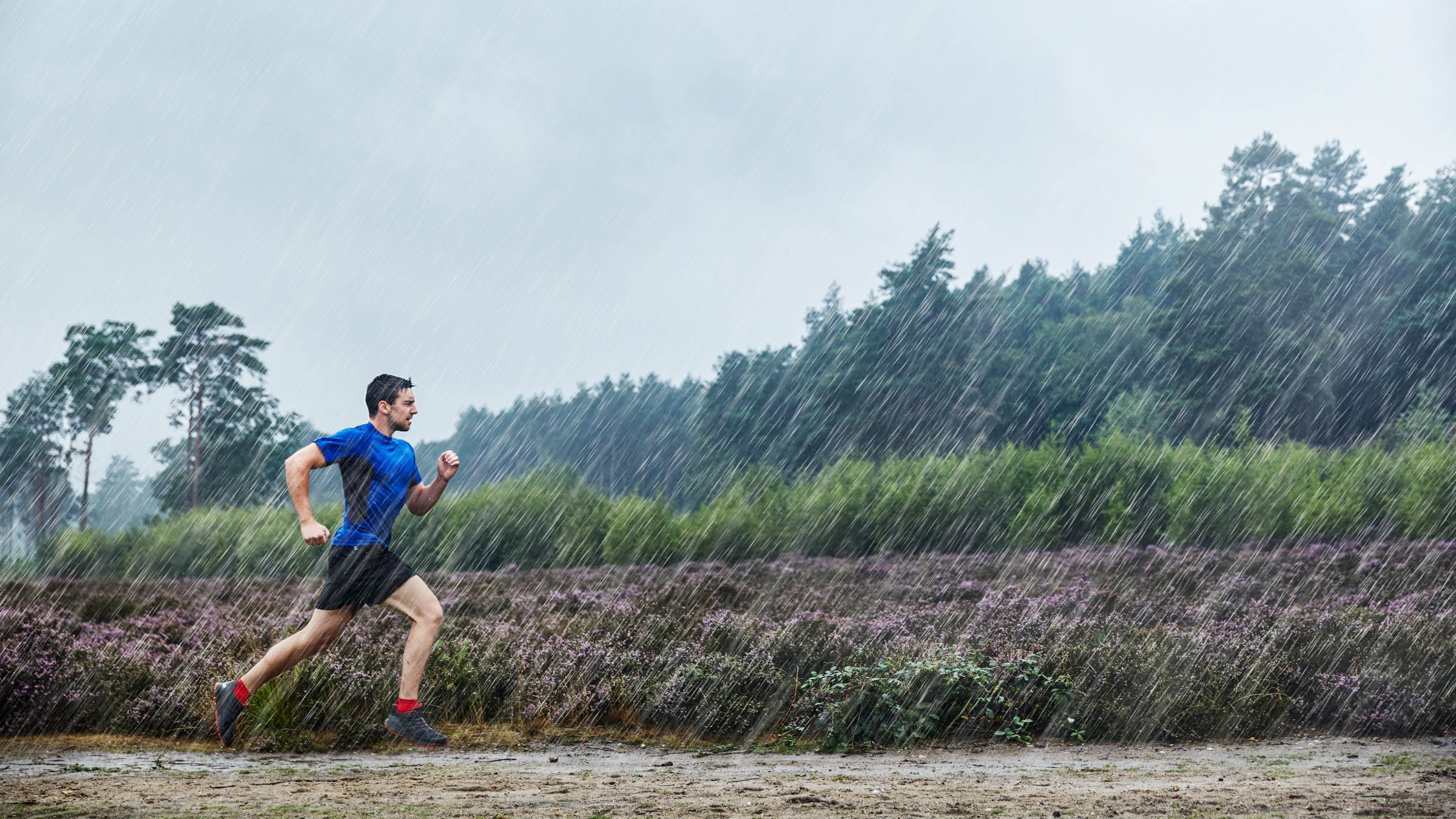 Man jogging through a rainstorm