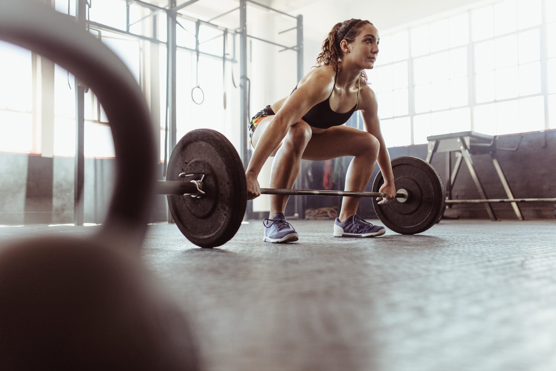 female runner lifting weights