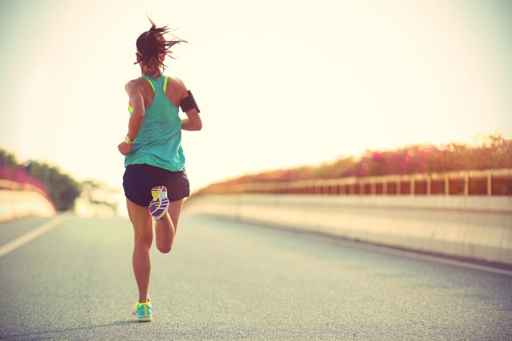 woman runner on bridge tempo run