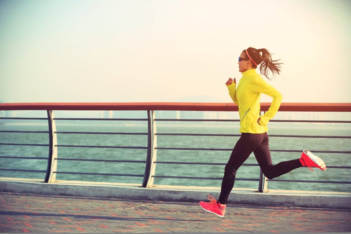 woman runner on bridge speed work