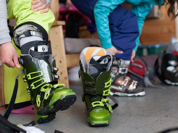 Skier putting on boots