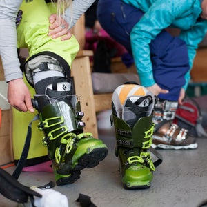 Skier putting on boots