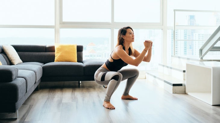 woman squatting for Iliotibial Band Pain relief 
