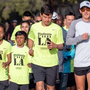 Students in SRLA shirts run with their teachers in the LA Marathon