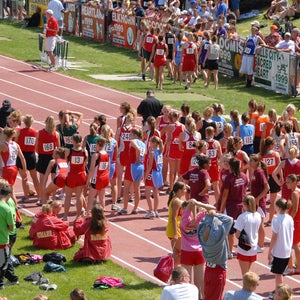 high school girl runners line up for the mile at state meet