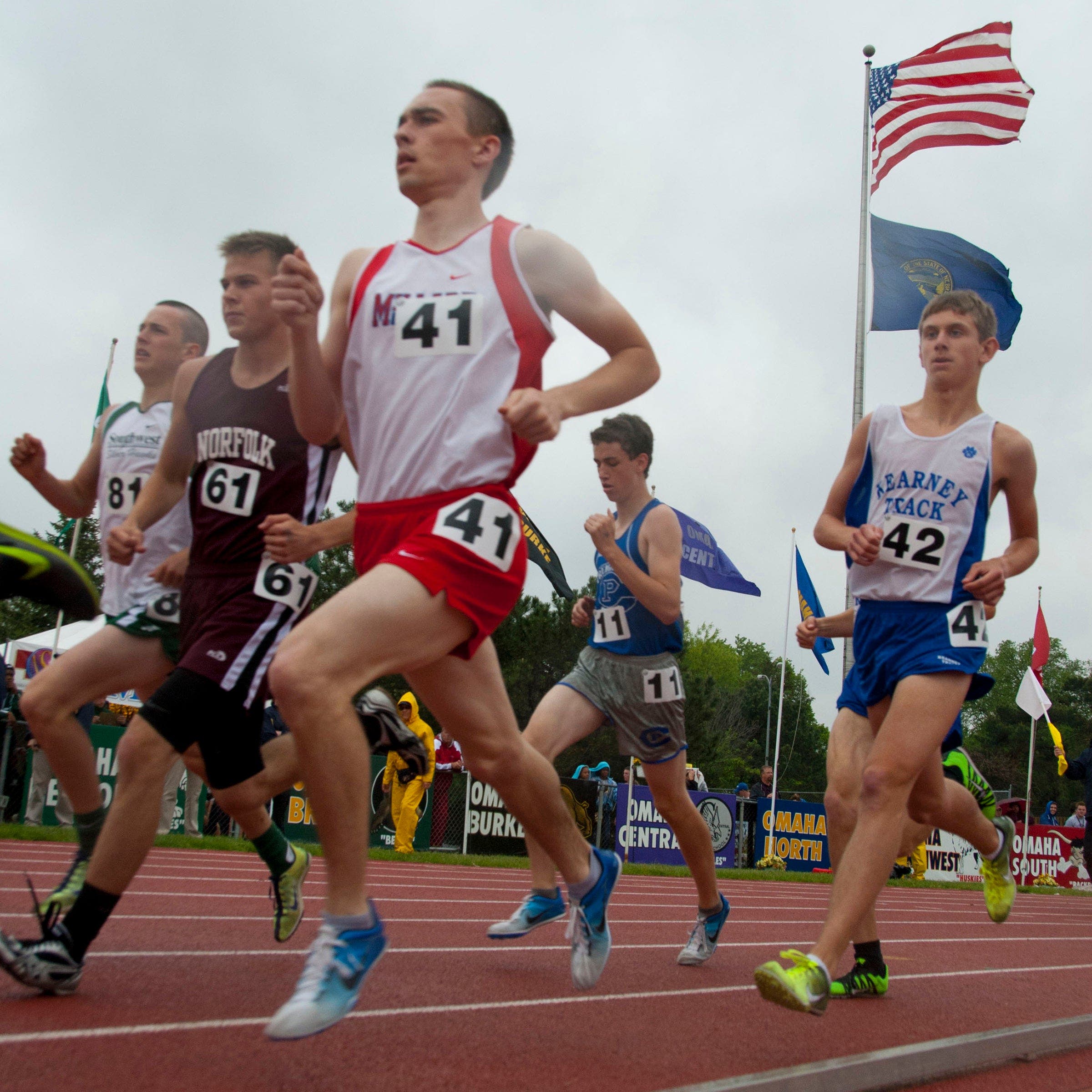 high school boys running on track in windy weather