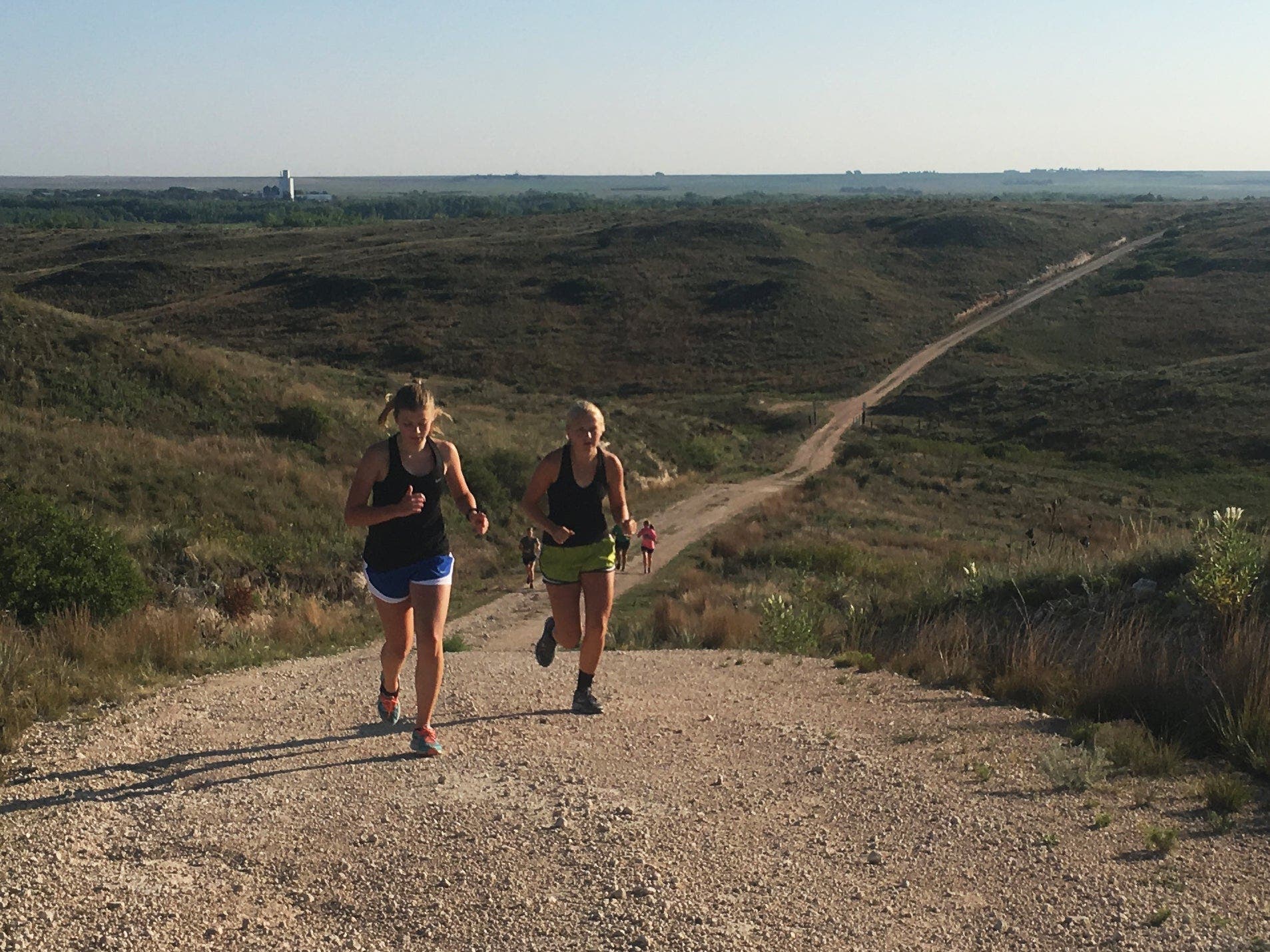 women runners on steep hill