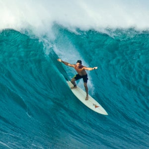 A surfer at Sunset Beach, north shore, Oahu, Hawaii.