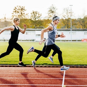 women running speed workout on track
