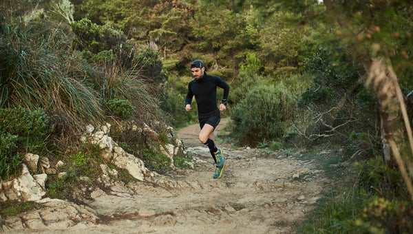 Athlete running along a trail