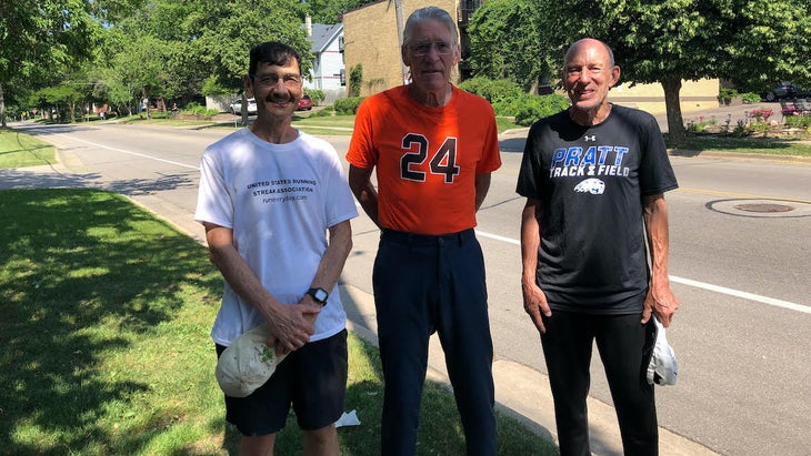 Three men posing for a picture.