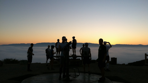 Runners on a hill at the crack of dawn.