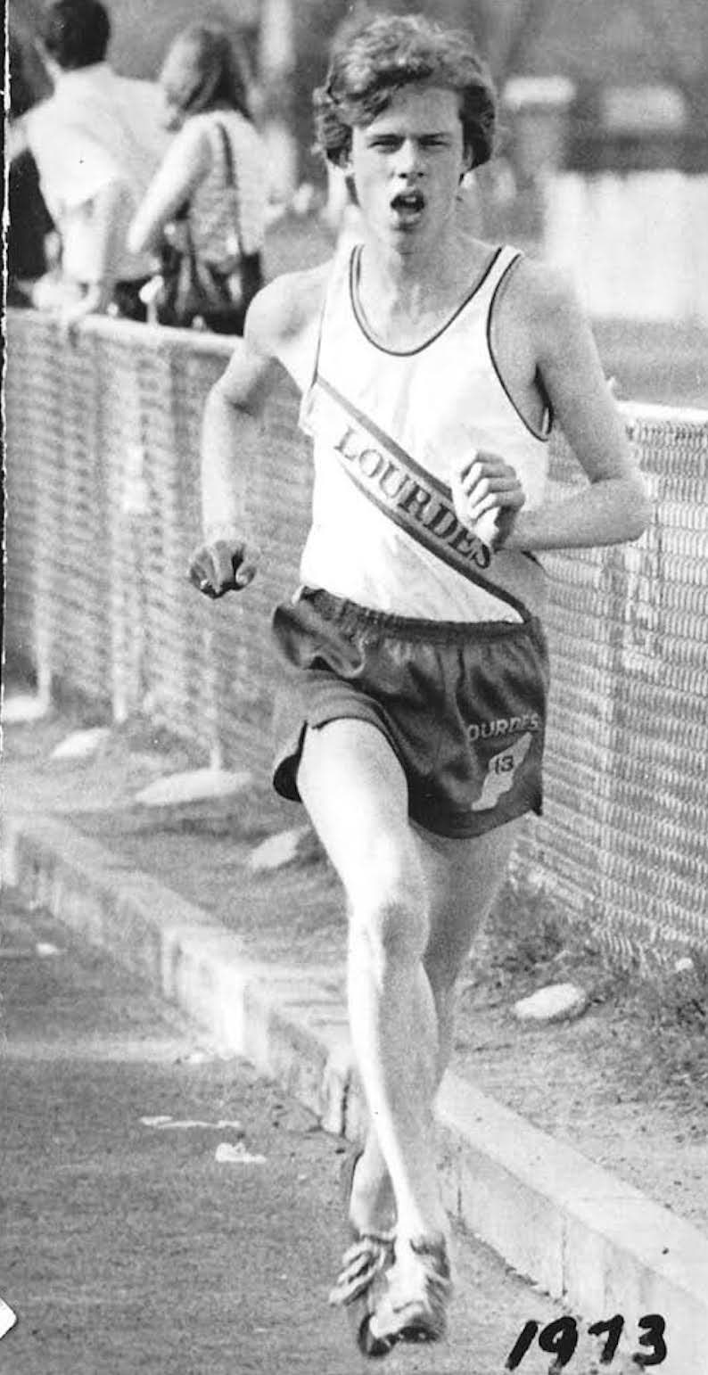 Black and white of boy running.