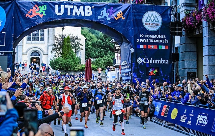Racers at UTMB under blue UTMB banner.