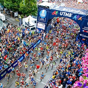 Aerial shot of a lot of runners on road at UTMB start line.