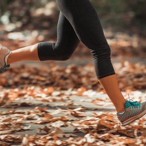 Woman Jogging Outdoors In Autumn