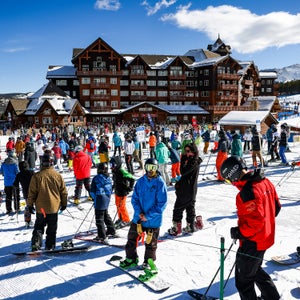 Skiers and snowboarders wait in line on opening day at Breckenridge Ski Resort in 2020.