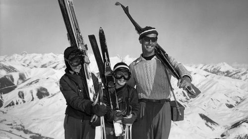 Vintage family carrying skis