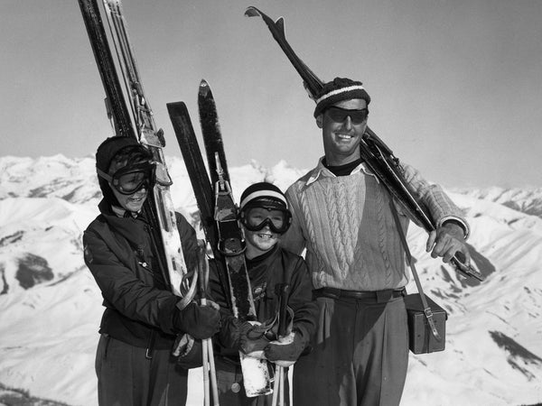 Vintage family carrying skis
